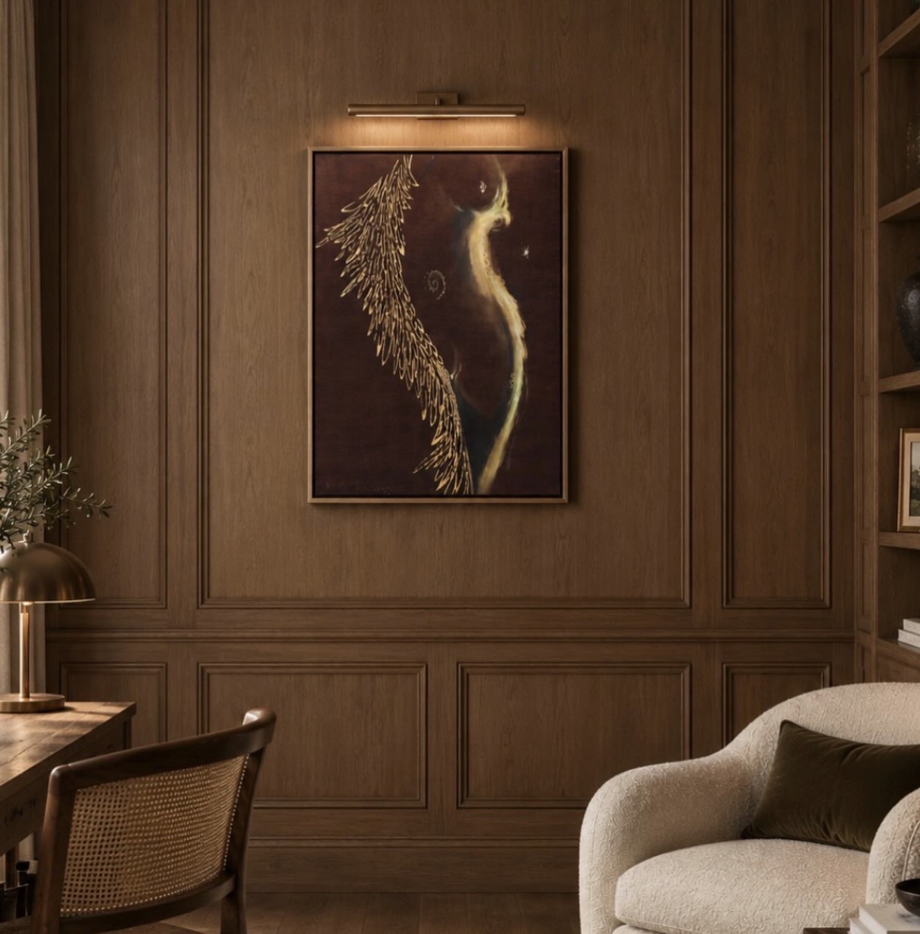 A framed painting above a cream armchair in a wood-panelled study